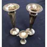 Two weighted silver vases (18cm high) hallmarks rubbed, together with a silver miniature trophy