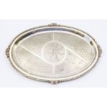 A silver Neo-classical oval tray, having a scrolled border with floral cast decoration to each side,