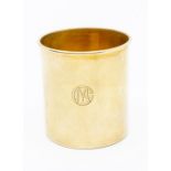 An early 20th Century French plain silver gilt tumbler, monogrammed, with Guarantee marks and