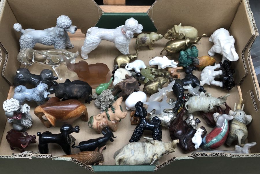 A large collection of ceramic, cast metal and glass animals, to include:- poodles, elephants and