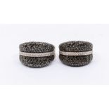 Two silver and black diamond rings, convex shaped pave set with round black diamonds, width