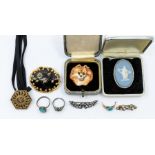 A collection of jewellery to include a Victorian seed pear, enamel and gilt metal mourning brooch,