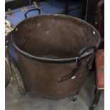 A large copper cauldron with cast iron mounts. Diameter approx 68cm, height approx 58cm.