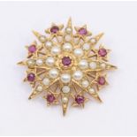 A Victorian ruby and seed pearl 9ct gold star brooch, the centre set with a round cut ruby within