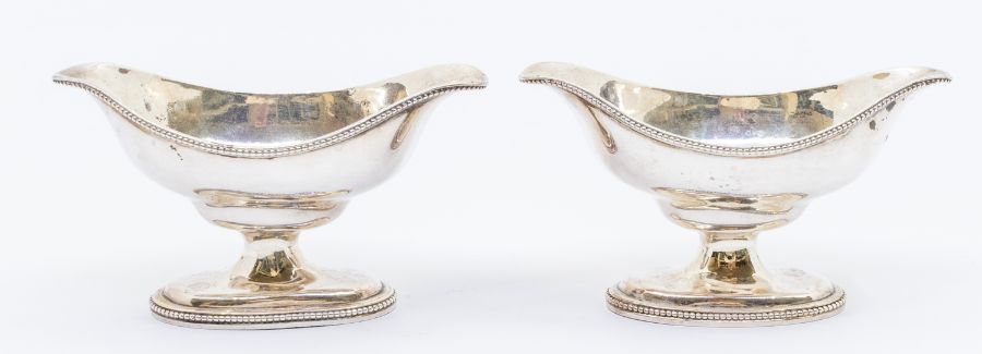 A pair of George III silver oval double lipped salts on raised feet, London, 1784, maker's mark