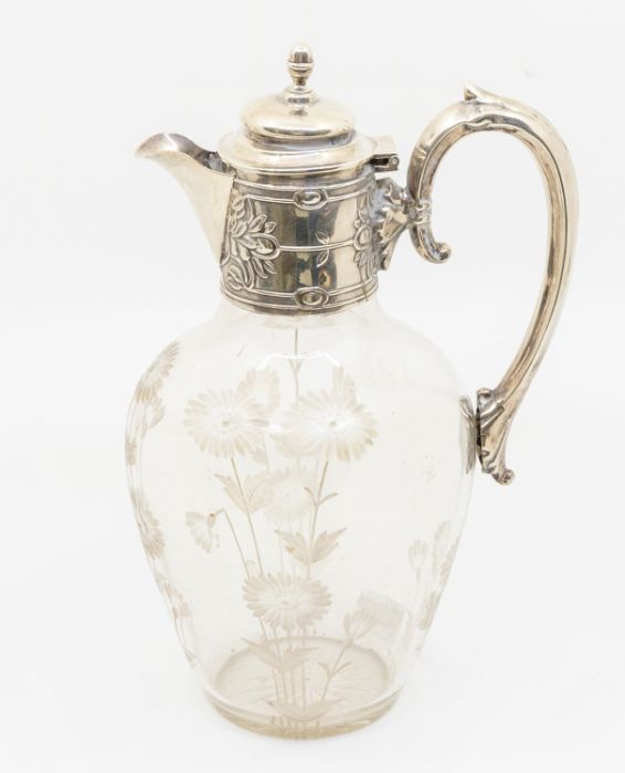 An Edwardian silver mounted claret jug, the mount chased with stylised flowers, with domed cover and