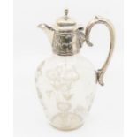 An Edwardian silver mounted claret jug, the mount chased with stylised flowers, with domed cover and