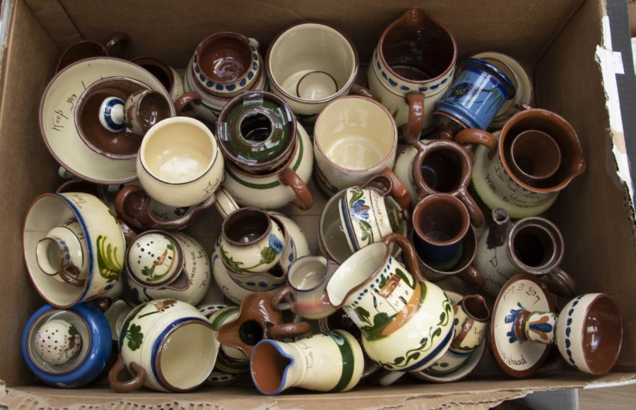A quantity of Torquay pottery to include mugs, bowls, puzzle jug etc