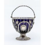 An early 20th Century silver  wire work sugar bowl, ropetwist handle above openwork body set with