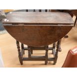 A late 17th Century small drop leaf oak table with turned legs, missing cutlery drawer