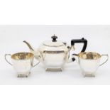 A George VI silver three piece tea service comprising teapot, sugar bowl and milk jug, the teapot