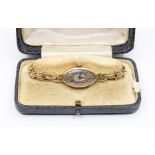 A 9ct gold cased ladies watch, circa 1920's, with oval silvered dial, Arabic numerals, dial 15 x