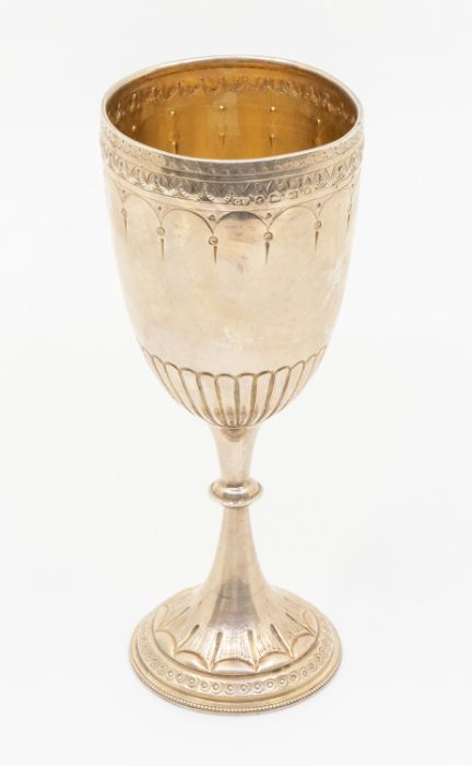 A late Victorian elongated silver goblet, engraved geometric border, gadroon lower section, the stem