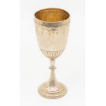 A late Victorian elongated silver goblet, engraved geometric border, gadroon lower section, the stem