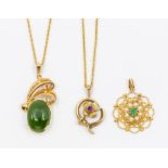 An emerald and pearl set 9ct gold pendant, comprising a central round cut emerald within a border of