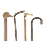 A collection of four walking sticks, to include hallmarked silver examples
