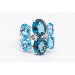 A large blue topaz 18ct white gold cluster ring, comprising claw set oval cut blue topaz of