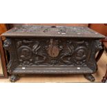 Small 19th Century carved Continental chest with carved grotesque head corners, classical carved