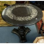 A round marble occasion table with marble base, inlaid passion flower detail to top