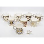 Collection of eight Royal Crown Derby commemorative loving cups, no boxes, one is damaged