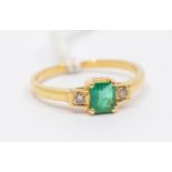 An emerald and diamond 18ct gold ring, claw set emerald-cut emerald to the centre, size approx. 5