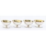 A matched set of four George III silver salts, boat shaped with beaded rims, engraved festoon