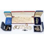 A collection of costume jewellery including a Rene Mackintosh style silver bracelet, silver brooch
