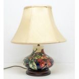 A late 20th Century Moorcroft table bluster lamp, with shade, on wooden base