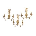 A set of three Neo-Classical style gilt brass wall lights, ribbon tied stem with central paterae,