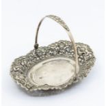 An 800 standard silver bon bon bowl with swing handle, the raised side chased with flowers, hammered