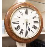 A late 19th Century, early 20th Century oak cased round wall clock, Roman numerals, eight day