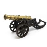 A pair of cast iron and brass table cannons