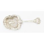 A Dutch style straining spoon, the centre bowl decorated with milkmaid within latticework, ornate
