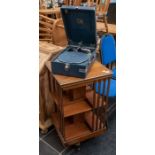 An Edwardian mahogany revolving bookcase; a HMV portable record player (2)