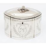 A Georgian style shaped oval silver tea caddy and cover, the body engraved with ribbon tied oval