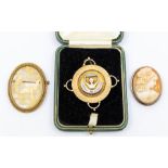 A collection of brooches to include; silver gilt presidents brooch, cased, together with two cameo