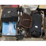 A collection of modern and vintage video cameras, cameras, including 1950's Bell & Howell in carry