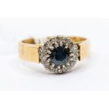A sapphire and diamond and 18ct gold ring, comprising claw set round cut sapphire approx. 5mm, set