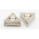 A pair of Victorian novelty shaped triangular salts, profuse Baroque style decoration on three