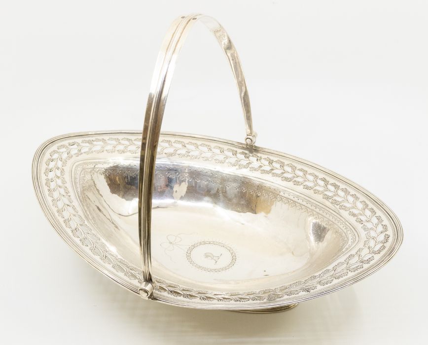 A George III silver navette shaped large bread basket with swing handle, the border bright cut