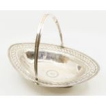 A George III silver navette shaped large bread basket with swing handle, the border bright cut