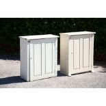A pair of white painted wall cabinets, each having a single two-panel door, enclosing a single shelf