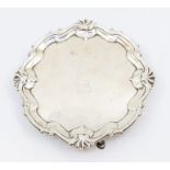 A George II cartouche shaped card tray / small salver, with raised stylised rocaille border, the