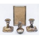 A pair of George V dwarf candlesticks, Birmingham, 1914 - one filled, AF - damages & tarnished,