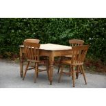 A Victorian pine kitchen table, having a plank top, fitted with a single drawer to frieze, raised on