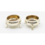 A pair of Victorian circular salts, on three hoof feet, hallmarked by George John Richards &