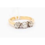 A three stone diamond and 18ct gold ring, comprising three old cut diamonds with a total diamond