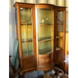 An Edwardian display cabinet, serpentine, glazed front, inlaid three internal shelves on sabre legs