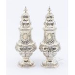 A pair of late Victorian silver casters, baluser shaped the bodies chased with festoons, ogee