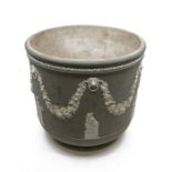 A Wedgwood green jasper jardiniere moulded with swags and Classical figures, impressed "Wedgwood",